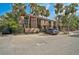 Home with lovely palm trees, gravel yard, and a convenient car park providing a welcoming curb appeal at 105 Pass Key Rd # 105, Sarasota, FL 34242