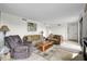 Inviting living room featuring comfortable seating, tile floors and access to a balcony at 105 Pass Key Rd # 105, Sarasota, FL 34242