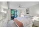 Inviting bedroom featuring a ceiling fan and sliding glass door to screened porch at 105 Pass Key Rd # 105, Sarasota, FL 34242