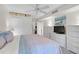Bright main bedroom with a ceiling fan, three dressers, and ensuite closet at 105 Pass Key Rd # 105, Sarasota, FL 34242