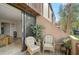 Comfortable patio with cushioned wicker chairs overlooking lush tropical landscaping at 105 Pass Key Rd # 105, Sarasota, FL 34242