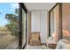 Relaxing sunroom with sliding glass doors offering beautiful views of the beach and palm trees at 105 Pass Key Rd # 105, Sarasota, FL 34242