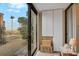 Bright sunroom with views of palm trees and storage cabinetry, creating a serene space at 105 Pass Key Rd # 105, Sarasota, FL 34242