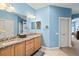 This bathroom includes double sinks, granite countertops, wood cabinetry, and well-lit mirrors at 1123 Riverscape St # D, Bradenton, FL 34208