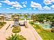 Beautiful Tidewater Preserve entrance featuring a scenic water feature, lush landscaping and secure gate access at 1123 Riverscape St # D, Bradenton, FL 34208