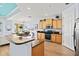 Open kitchen featuring wood cabinets, granite countertops, stainless steel appliances, and a breakfast bar at 1123 Riverscape St # D, Bradenton, FL 34208