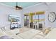 Bright living room with a view of the water, large sliding glass doors to the balcony, and contemporary furniture at 1123 Riverscape St # D, Bradenton, FL 34208