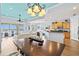 Open-concept living room with hardwood floors, modern furnishings, and a sliding glass door to the patio at 1123 Riverscape St # D, Bradenton, FL 34208