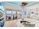 Bright living room featuring a view of the water, large sliding glass doors to the balcony, and contemporary furniture at 1123 Riverscape St # D, Bradenton, FL 34208