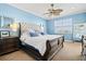This serene main bedroom offers a plush king bed, ceiling fan and neutral carpet flooring at 1123 Riverscape St # D, Bradenton, FL 34208