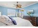 The main bedroom features a view of the water from a screened lanai, neutral carpet and ceiling fan at 1123 Riverscape St # D, Bradenton, FL 34208
