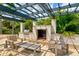 Inviting outdoor lounge area with a grill, fireplace, comfortable seating, and lush landscaping at 1123 Riverscape St # D, Bradenton, FL 34208
