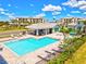 Enjoy this community pool with shaded seating areas, lush landscaping, and clear blue water at 1123 Riverscape St # D, Bradenton, FL 34208