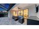 Covered patio area with wicker furniture and a sliding door into the living room at 11606 Apple Tree Cir, Bradenton, FL 34211