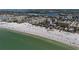 Expansive aerial view of a pristine white sand beach, turquoise water, and nearby waterfront condo community at 1163 Coquille St # 207, Sarasota, FL 34242
