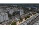 Aerial view of a residential community showing the houses, pool, palm trees and waterfront at 1163 Coquille St # 207, Sarasota, FL 34242