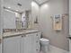 Bathroom showcases a granite countertop, modern fixtures, and a sleek, tiled walk-in shower at 1163 Coquille St # 207, Sarasota, FL 34242