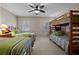 Spacious bedroom with bunk beds and two twin beds, decorated with striped green bedding at 1163 Coquille St # 207, Sarasota, FL 34242