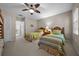 Charming bedroom with two twin beds, bunk bed in view, and a ceiling fan for added comfort at 1163 Coquille St # 207, Sarasota, FL 34242