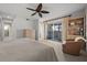 Spacious main bedroom with a slider to the enclosed porch, neutral carpet, and an ensuite bathroom at 1163 Coquille St # 207, Sarasota, FL 34242