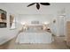 Comfortable bedroom offering a ceiling fan, neutral tones, and windows for plenty of natural light at 1163 Coquille St # 207, Sarasota, FL 34242