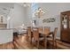 Elegant dining room with a large window, stylish chandelier, and an adjacent living room with comfortable seating at 1163 Coquille St # 207, Sarasota, FL 34242