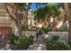 Inviting exterior of a multi-story building with lush landscaping and classic architectural details, creating a welcoming atmosphere at 1163 Coquille St # 207, Sarasota, FL 34242