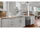 Spacious kitchen with stainless steel appliances, granite countertops, and an open layout, with an island overlooking the dining area at 1163 Coquille St # 207, Sarasota, FL 34242