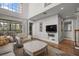 Inviting living area with a TV, comfortable seating, and a view of the screened lanai at 1163 Coquille St # 207, Sarasota, FL 34242