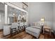 Cozy living space featuring a comfortable sofa and ottoman, with a partial view of the adjacent kitchen area at 1163 Coquille St # 207, Sarasota, FL 34242