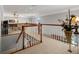 Open loft space with wood railing overlooking the lower level of the home at 1163 Coquille St # 207, Sarasota, FL 34242