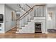 Elegant staircase with white banisters, wood railing, and convenient under-stair storage with built-in wine cooler at 1163 Coquille St # 207, Sarasota, FL 34242