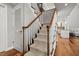 Staircase features wood railings, neutral carpet, and wood floors visible from the landing at 1163 Coquille St # 207, Sarasota, FL 34242
