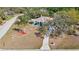 Aerial view of home featuring an expansive front yard, mature trees, and a well-maintained driveway at 12103 Shadow Run Blvd, Riverview, FL 33569