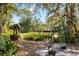 Lush backyard with mature trees, tropical plants, and stone pavers at 12103 Shadow Run Blvd, Riverview, FL 33569