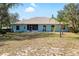 Rear exterior view of the home showcasing the covered lanai and expansive backyard at 12103 Shadow Run Blvd, Riverview, FL 33569
