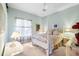 Bright bedroom with a four poster bed, neutral carpet, and light blue walls at 12103 Shadow Run Blvd, Riverview, FL 33569