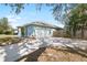 Side view of a light blue home showcasing the garage, a fenced yard, and a spacious driveway at 12103 Shadow Run Blvd, Riverview, FL 33569