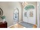 Welcoming foyer features arched doorways, decorative front doors, and elegant light fixtures at 12103 Shadow Run Blvd, Riverview, FL 33569