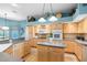 Charming kitchen with wood cabinetry, island, and updated appliances, perfect for cooking and gathering at 12103 Shadow Run Blvd, Riverview, FL 33569