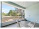 Enclosed lanai featuring a ceiling fan and views of the wooded backyard at 12103 Shadow Run Blvd, Riverview, FL 33569