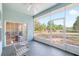 Enclosed lanai with neutral furniture and a view of the fenced backyard at 12103 Shadow Run Blvd, Riverview, FL 33569