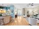 Open-concept living area with light blue accents, hardwood floors, and a view into the foyer at 12103 Shadow Run Blvd, Riverview, FL 33569