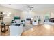 Bright living room featuring hardwood floors, a fireplace, and comfortable seating arrangements at 12103 Shadow Run Blvd, Riverview, FL 33569