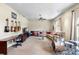 Spacious living room featuring neutral carpet, ceiling fan, large couch, and musical instruments at 12103 Shadow Run Blvd, Riverview, FL 33569