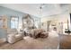 Relaxing primary bedroom featuring a tray ceiling, ensuite, and comfortable seating at 12103 Shadow Run Blvd, Riverview, FL 33569