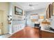 Bright home office featuring wood flooring, built-in shelving, and an abundance of natural light at 12103 Shadow Run Blvd, Riverview, FL 33569