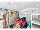 Well-organized shed interior with a lawn mower and pegboard storage for tools and equipment at 12103 Shadow Run Blvd, Riverview, FL 33569