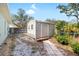 Durable metal shed with a wooden base and walkway, offering secure storage space in the backyard at 12103 Shadow Run Blvd, Riverview, FL 33569