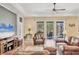 Spacious living room with tile floors, a ceiling fan and access to the outside patio at 1219 Thornbury Dr, Parrish, FL 34219